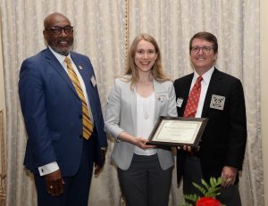 Julia Burgess (DMD 2024 candidate) receiving the Most Outstanding Presentation in Basic Science Research Award certificate